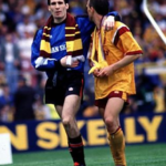 An injured Ally Maxwell and Luc Nijholt make their way around the Hampden pitch.